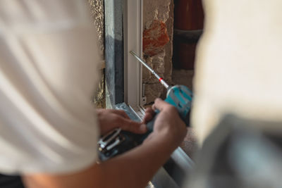 Midsection of man repairing car