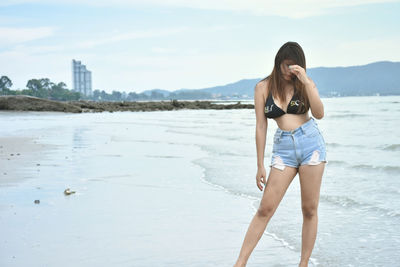 Beach time recreation concept. young asian model in posing on sea beach.