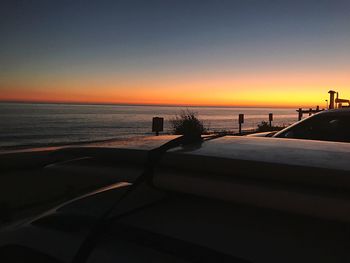 Scenic view of sea against clear sky during sunset