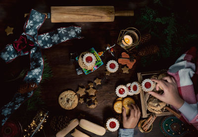 High angle view of kids crop hand standing on table