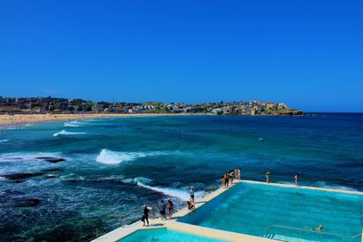 High angle view of swimming pool against clear blue sky