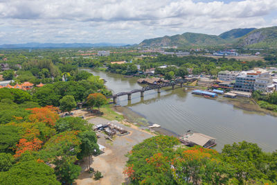 High angle view of river amidst trees against sky