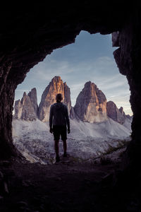 Rear view of man standing on rock