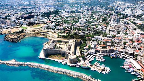 Aerial view of buildings by sea 