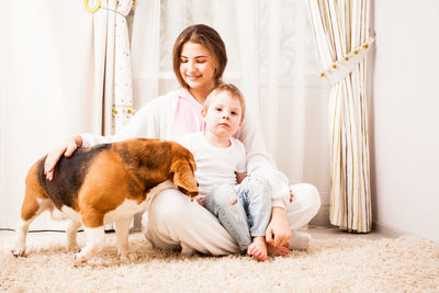 Happy woman sitting on floor