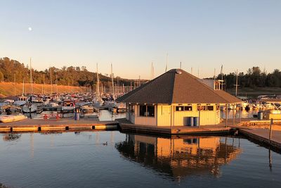 Boats in harbor at sunset