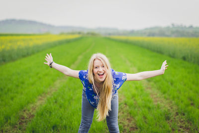 Portrait of smiling young woman in field