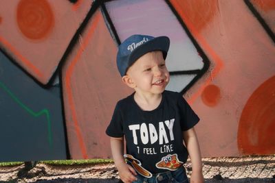 Boy standing against wall