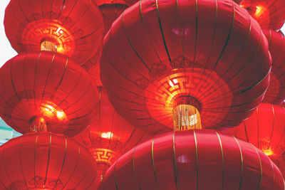 Low angle view of illuminated lanterns hanging at night