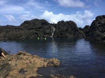 Scenic view of rocks and sea against sky