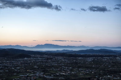 Aerial view of townscape against sky during sunset