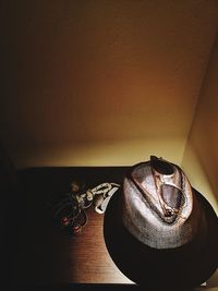 High angle view of hat on table against wall at home