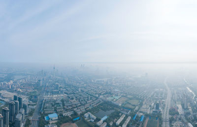 High angle view of city buildings against sky