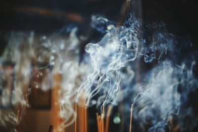 Close-up of burning incenses at temple