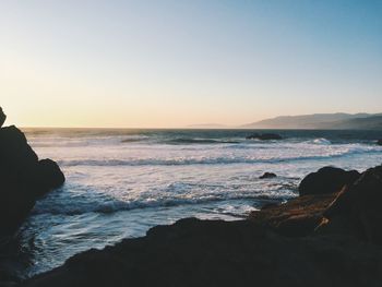 Scenic view of sea against clear sky during sunset