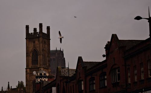 Low angle view of buildings in city against sky