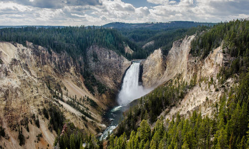 Scenic view of waterfall against sky