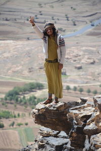 Full length of man standing on rock