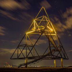 Low angle view of illuminated bridge against sky at night