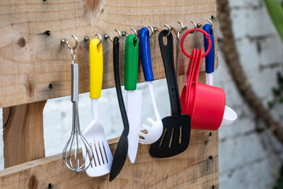 Close-up of utensils hanging on wall