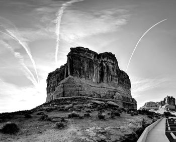 Low angle view of rock formation against sky