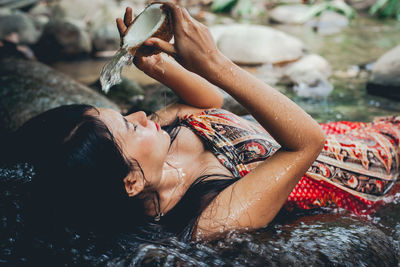 Young woman bathing in river