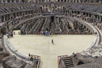 People in historical building against sky