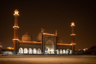 Illuminated building against sky at night