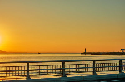 Scenic view of sea against orange sky