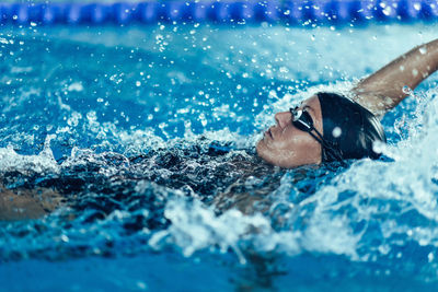 Woman swimming in pool during competition