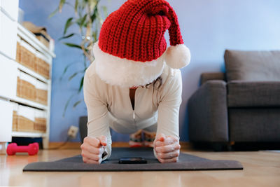 Portrait of young woman sitting on sofa at home