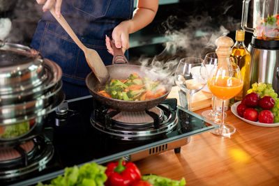 Midsection of man preparing food on table