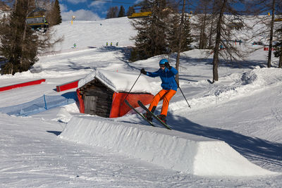 Man skiing on snow covered land