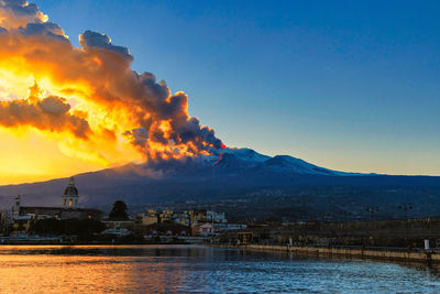 Panorama of the ionian coast with the eruption of etna