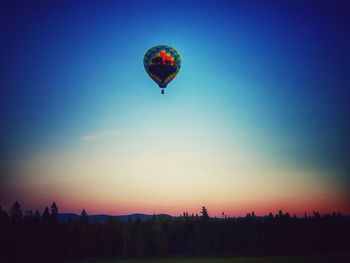 Silhouette hot air balloon against clear sky