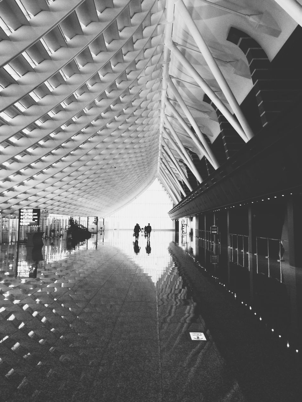 architecture, built structure, the way forward, indoors, ceiling, diminishing perspective, incidental people, men, walking, sunlight, shadow, lifestyles, transportation, empty, person, vanishing point, large group of people, connection, walkway