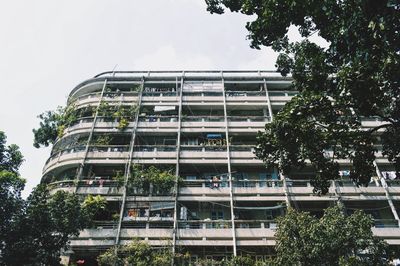 Low angle view of building and trees against sky