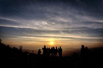 Silhouette people against sky during sunset