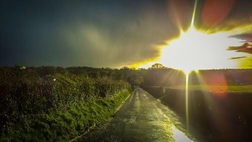 Scenic view of field against sky at sunset