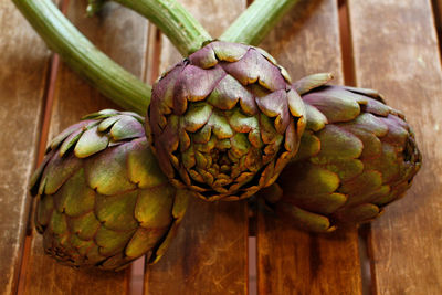 Close-up of fruits hanging on wood