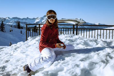 Portrait of woman skiing on snow