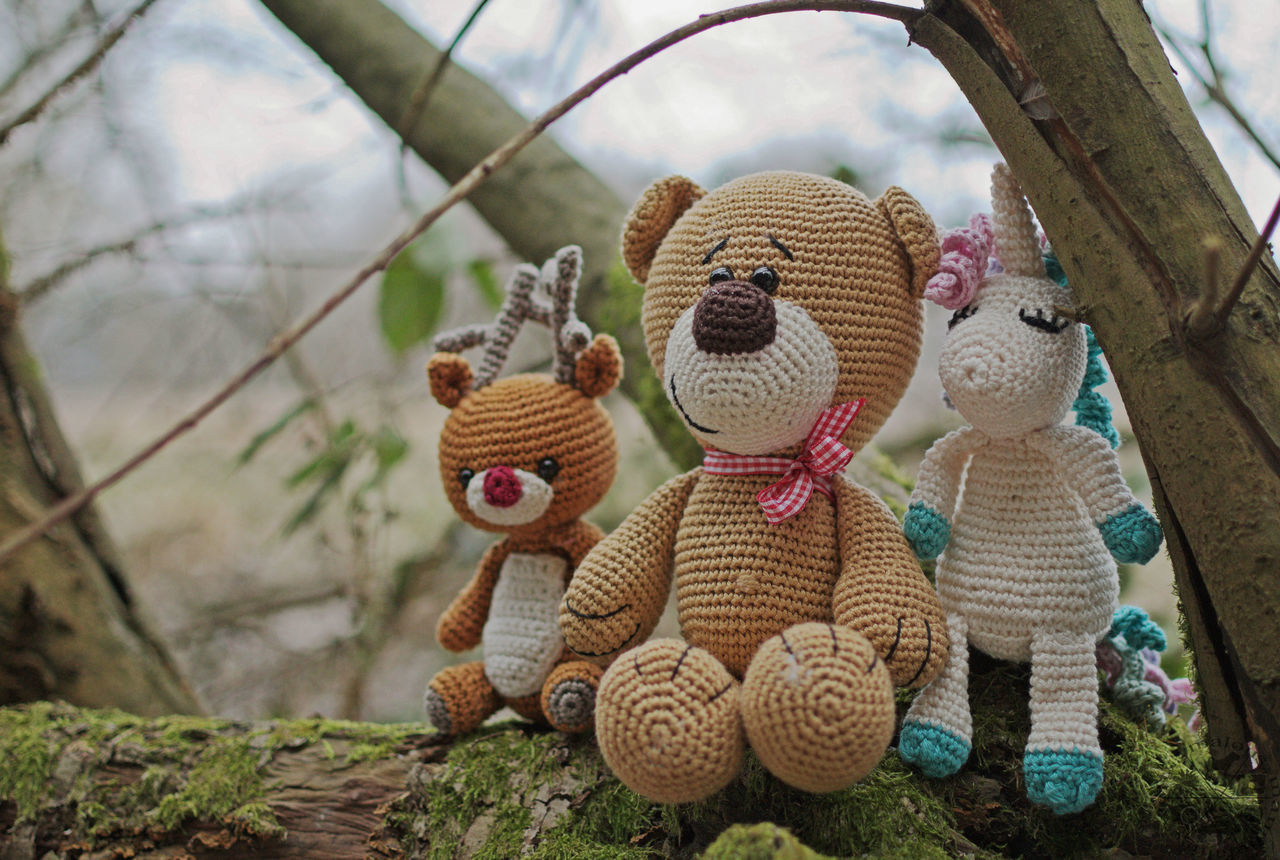 no people, stuffed toy, focus on foreground, outdoors, close-up, day, tree, nature, sky, scarecrow