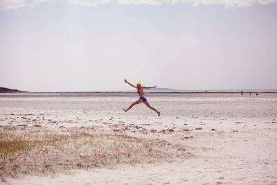 Woman jumping in beach