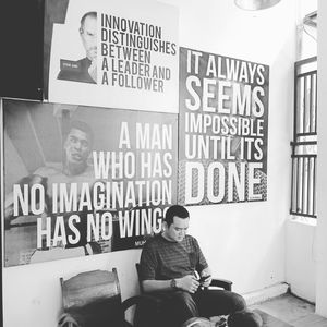 Full length of young man sitting on seat