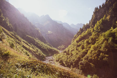 High angle view of valley and mountains against sky