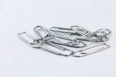 High angle view of metallic objects over white background