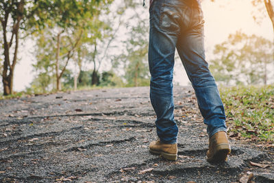 Low section of man standing on ground