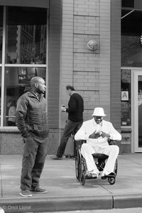 Man with umbrella standing on street