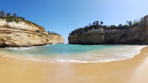 Panoramic view of sea against clear blue sky