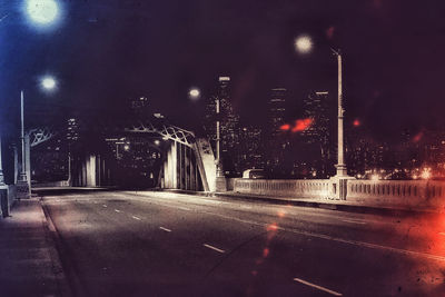 View of illuminated street lights at night